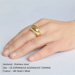 Minimalist dome-shaped stainless steel ring in 14K gold finish worn on a finger