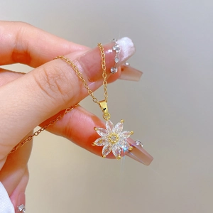 Elegant gold titanium steel necklace featuring a sparkling crystal floral bud pendant
