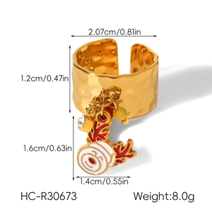 Close-up of golden hammered ring with Christmas snowman pendant and dimensional data