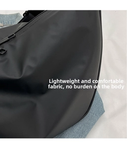 Detailed macro view of the black waterproof oxford fabric and smooth metal zipper closure