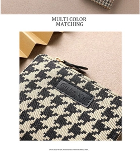 Close-up of houndstooth fabric texture and black leather label on a mini coin purse