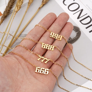 Gothic gold angel number necklaces showing 666 to 999 pendants on a vintage magazine