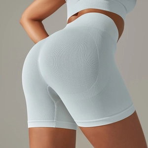 Detail of light blue high-waisted seamless yoga shorts showing honeycomb texture and lift
