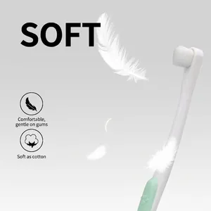 Soft bristle pet toothbrush for dogs and cats with light green non-slip handle