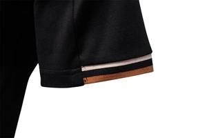 Macro detail of men's polo shirt black knit cuff with tri-color striped ribbing