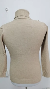 Close-up of the back view of a slim-fit khaki turtleneck sweater showing knit texture