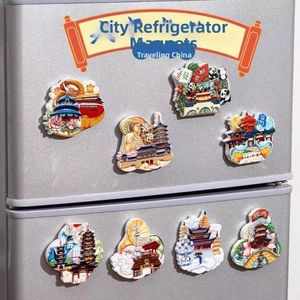 Detail view of 3D embossed resin city magnets featuring landmarks on metal surface