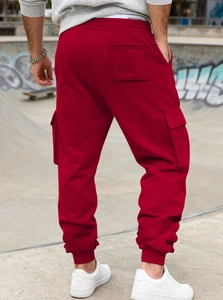 Rear view of red heavy-fleece cargo sweatpants featuring elastic cuffs and side pockets