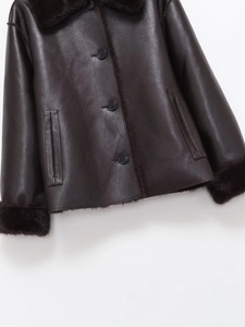 Close-up of deep brown leather jacket showing premium texture and fur trim detail