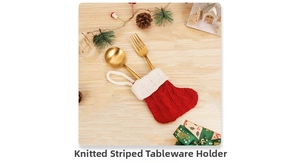 Close-up of red and white striped knit Christmas stocking cutlery set with golden utensils