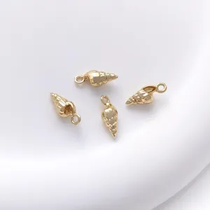 Detailed view of four 14K gold-plated conch pendants for DIY jewelry making and crafts