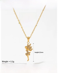 Macro shot of gold angel pendant necklace featuring sparkling white rhinestones on white