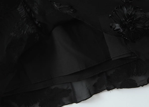 Detail of floral embroidery on black lace mesh fabric with premium corset lining
