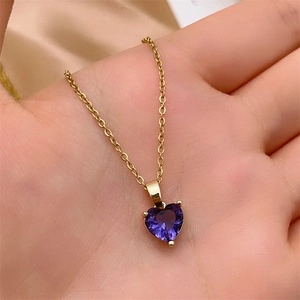 Close-up of heart-shaped purple zircon pendant on a gold-plated stainless steel chain