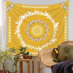 Detail of yellow mandala tapestry with pink roses and white leaves in boho room decor