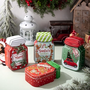 Close-up of festive Christmas tin storage containers with Santa and holiday graphics