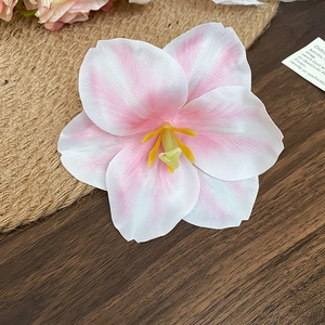 Floral hair clip featuring white and pink gradient silk petals with a pearl accent