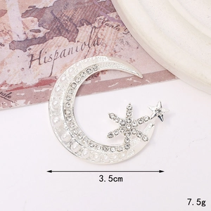 Star and moon brooch with pearls and rhinestones measuring 3.5cm on a vintage map background