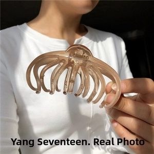 Macro detail of amber resin hair claw clip with large teeth for French bun hairstyles