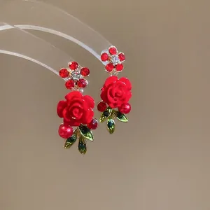 Vintage rose drop earrings with red resin flowers, green crystals and gold metal finish