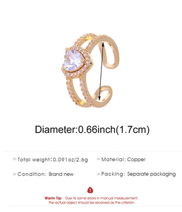 Detail of gold copper ring with heart-shaped white zircon and sparkling pave crystals