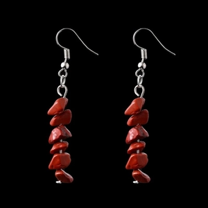 Close-up of irregular red natural crystal stone bead dangle earrings with silver hooks