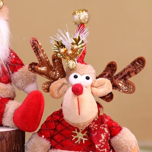 Close-up of a Christmas reindeer plush toy with red sequin coat and festive leaf detail