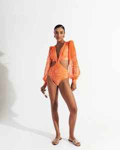 Detail view of orange floral swimsuit featuring sheer mesh lantern sleeves and side cut-outs