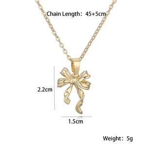 Detailed view of golden bow pendant necklace with chain length and size dimensions