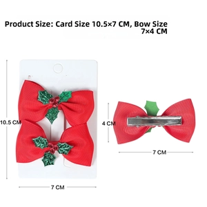 Close-up of red Christmas bow hair clips with green holly leaf detail and silver duckbill clips
