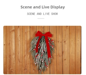 Detail of Christmas swag with red berries and velvet bow on snowy pine branches