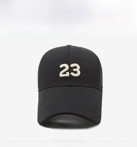 Close-up of black sports baseball cap with white 3D embroidery of number 23