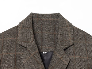 Close-up of lapel detail on taupe herringbone linen blend blazer with size S label
