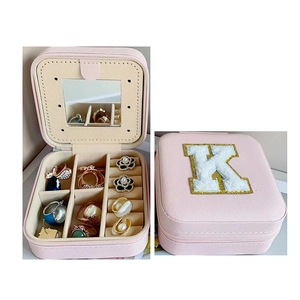 Pink portable jewelry box with letter K and internal mirror for rings and earrings