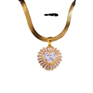 Golden snake chain necklace with sparkling heart zircon pendant on white background