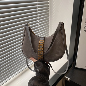 Minimalist dark gray suede crescent hobo bag with gold metal buckle and lettering