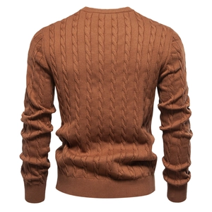 Detail of caramel brown knitted sweater with premium cable knit pattern on the back