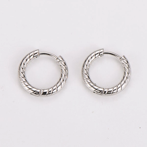 Macro shot of silver stainless steel hoop earrings featuring distinctive spiral textures