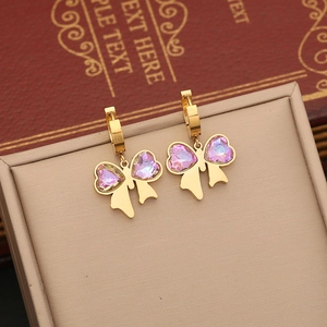 Elegant gold butterfly earrings with purple crystal wings on a beige display box