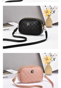 Close-up of quilted shoulder bag with camellia badge and dual zipper detailing