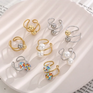 Detail view of multi-style ear cuff set with pearls and rhinestones on a display tray