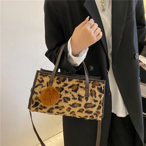 Fashionable leopard print faux fur tote bag styled with black blazer and brown charm