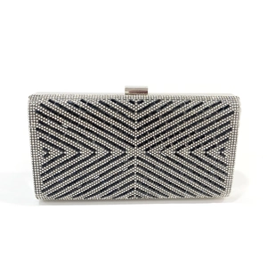 Macro shot of geometric X-pattern rhinestones on a black evening clutch purse