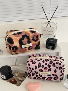 Close-up of leopard print makeup bags with square design and premium brand label detailing