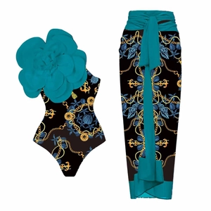 Detail of one-shoulder swimsuit with 3D floral accent and matching nautical print sarong
