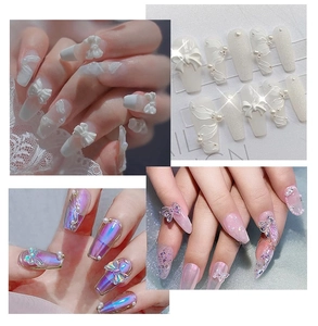 Macro view of 3D aurora resin butterfly and pearl charms on assorted press-on nail sets