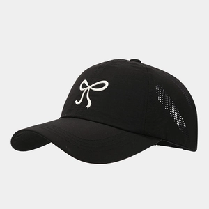 Detail view of black quick-dry baseball cap featuring breathable side laser-cut vents