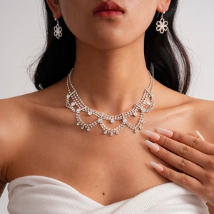 Elegant silver rhinestone necklace set with fringe pendant and matching flower earrings