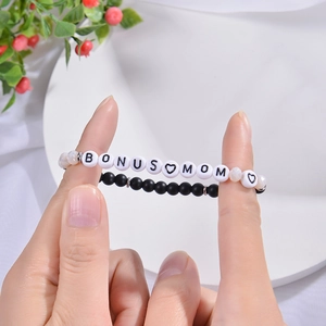 Close-up of handmade BONUS MOM beaded bracelet with black matte stones and acrylic letters
