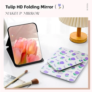 Detail of portable tulip pattern folding makeup mirror in desktop setup